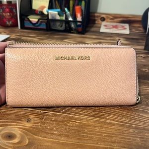 Michael kors wallet. In between a blush and a nude color.